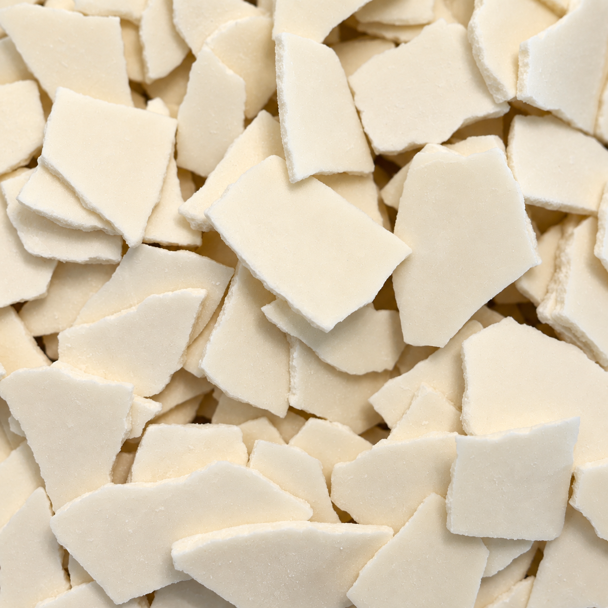 Close-up of Rareform white crème pieces showing their thin, irregular shapes